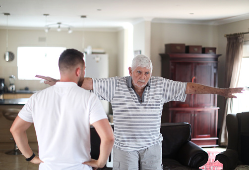 Photograph of a physical therapist testing an elderly patient's balance